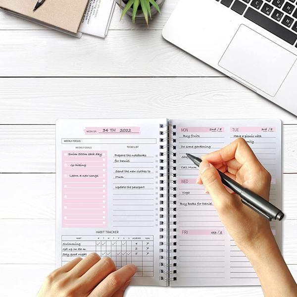making decisions in advance with a planner and notebook at home